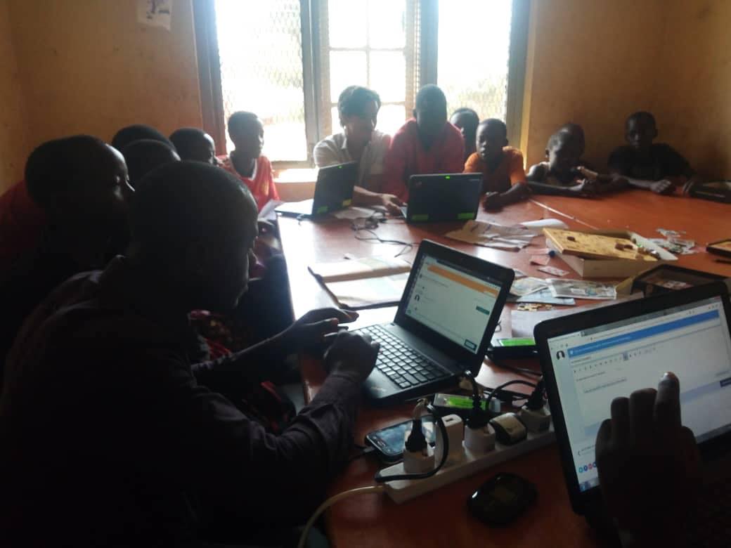 children on laptops in a classroom