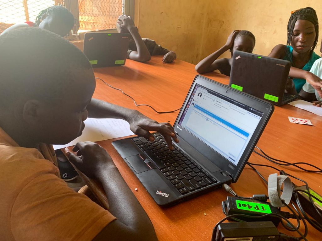 children on laptops in a classroom