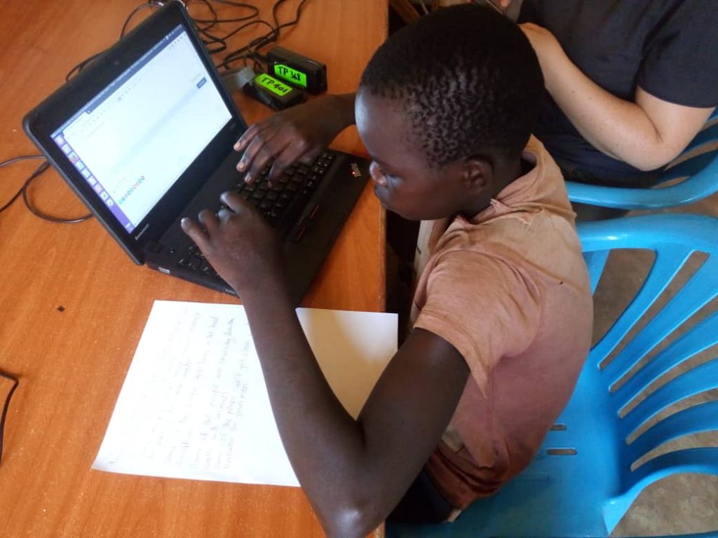A child works on a laptop