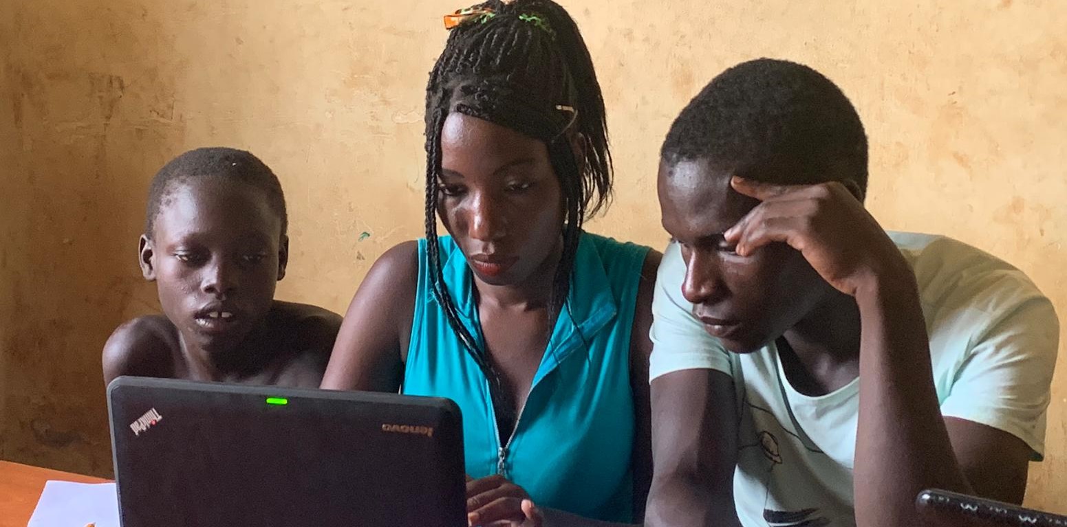 children on laptops in a classroom