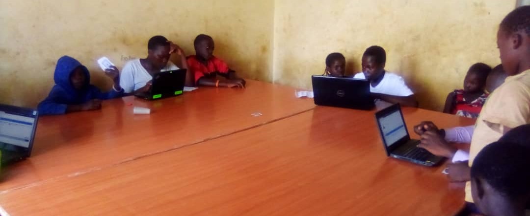 children on laptops in a classroom