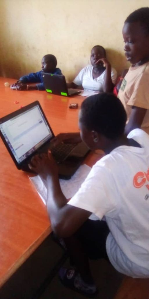 children on laptops in a classroom