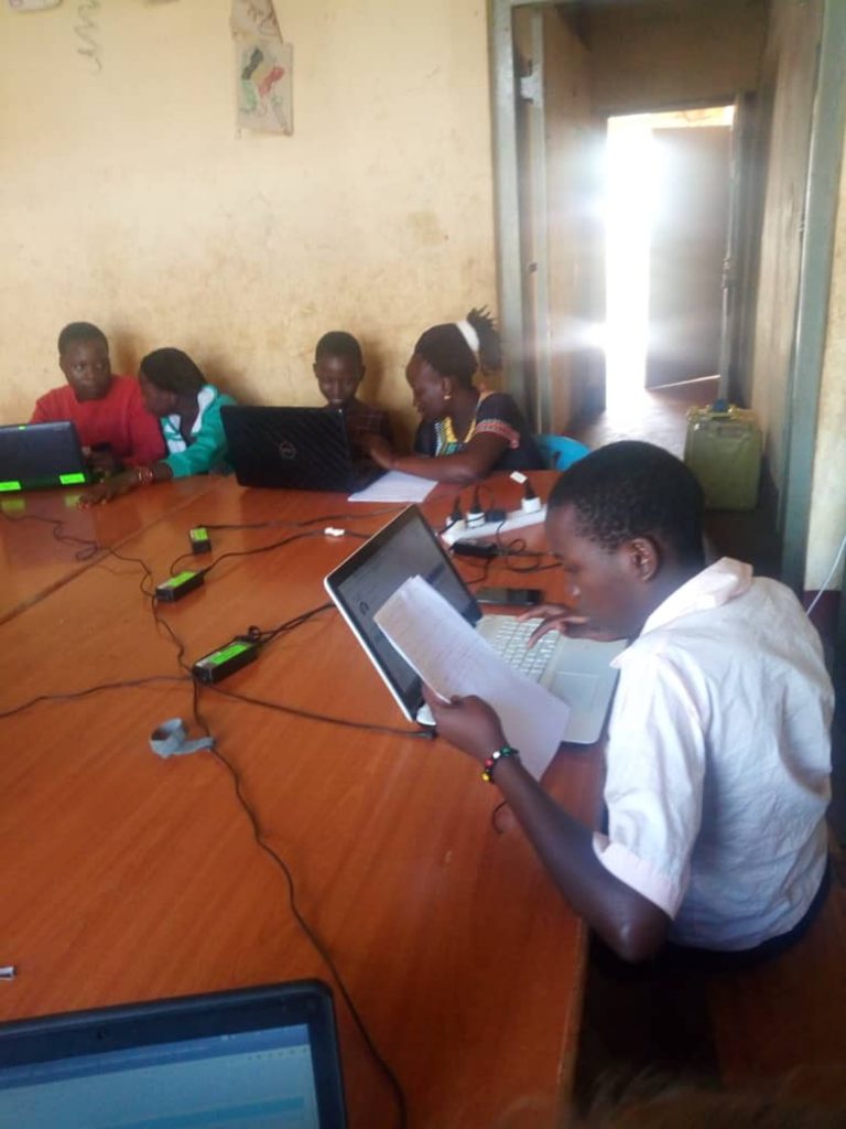 children on laptops in a classroom