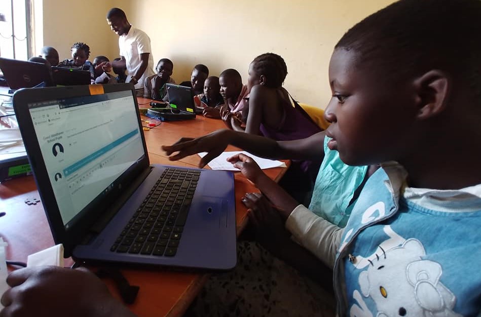 children on laptops in a classroom