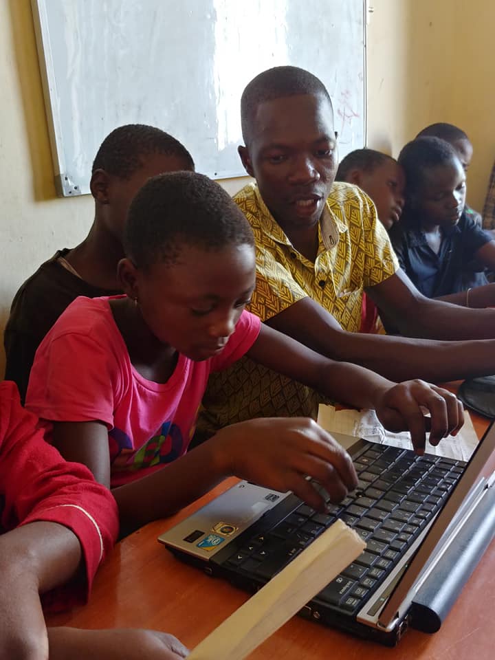 children on laptops in a classroom