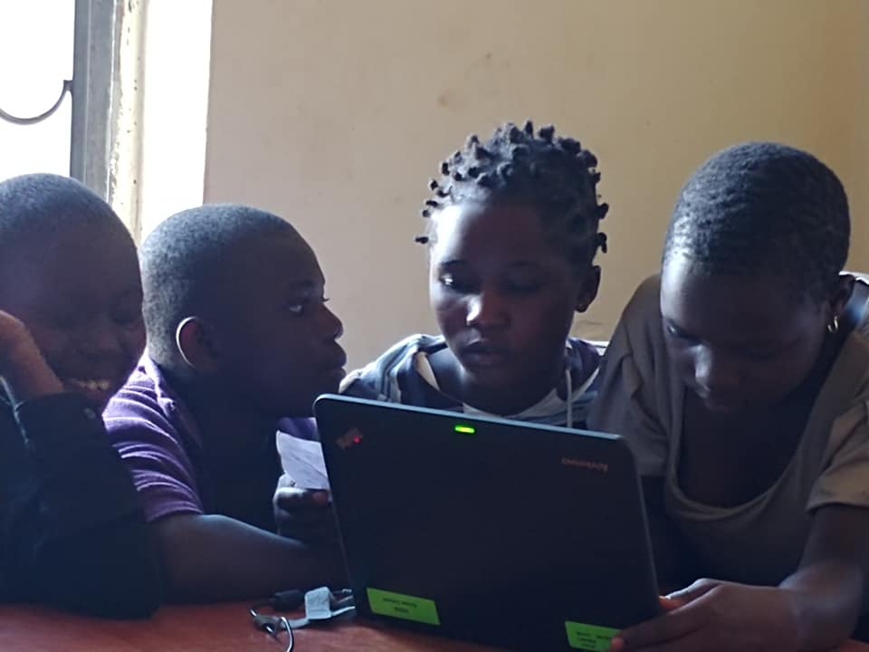 children on laptops in a classroom