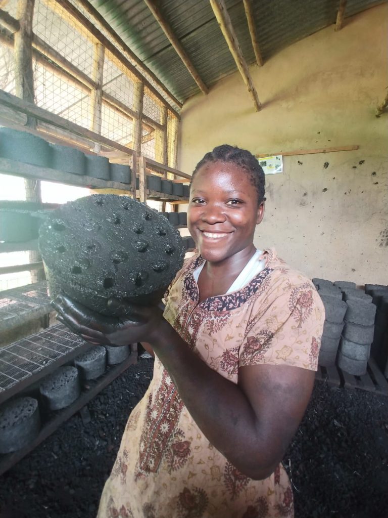 volunteer holding a briquette