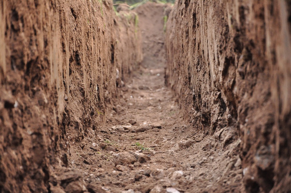 stock image of a mud road with high wall