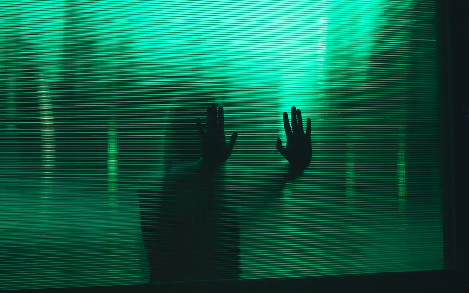 stock image of a child's handprints against a window