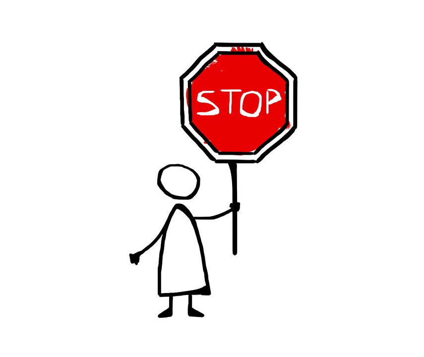 stock image of a stick person carrying a stop sign
