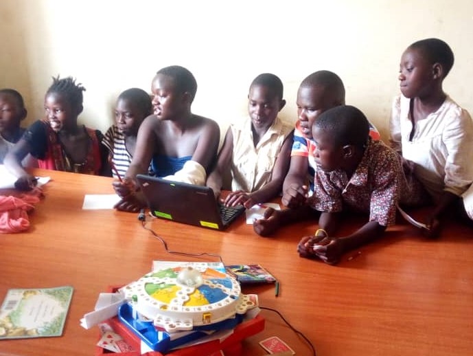 children on laptops in a classroom