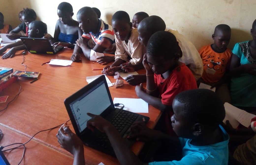 children on laptops in a classroom