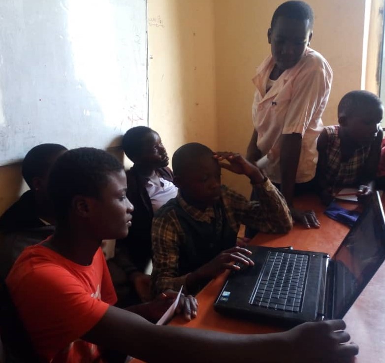 children on laptops in a classroom