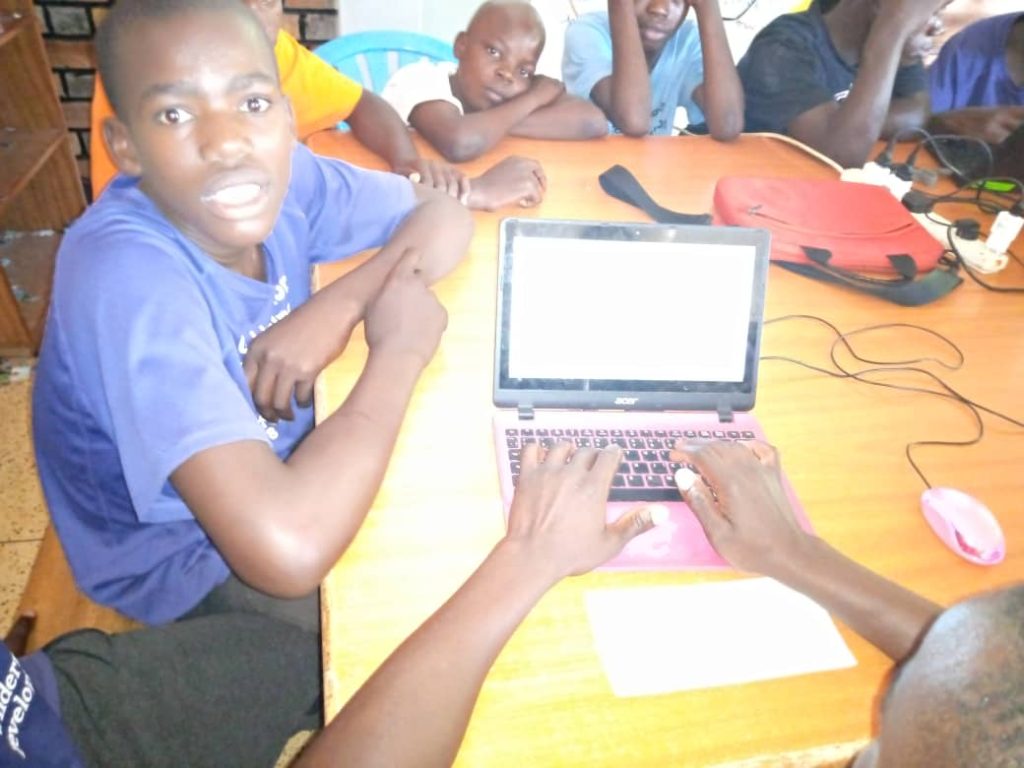 children on laptops in a classroom