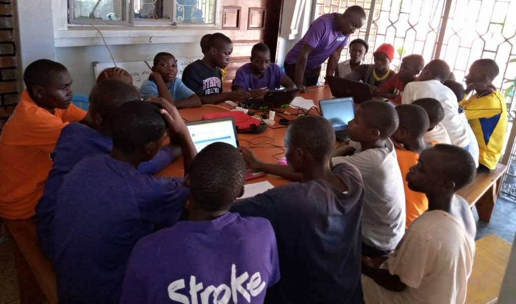 children on laptops in a classroom