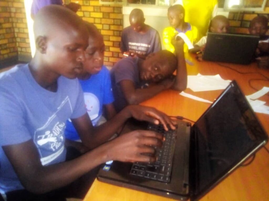 children on laptops in a classroom