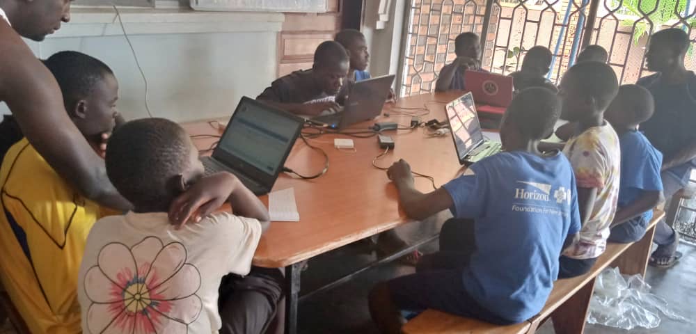 children on laptops in a classroom