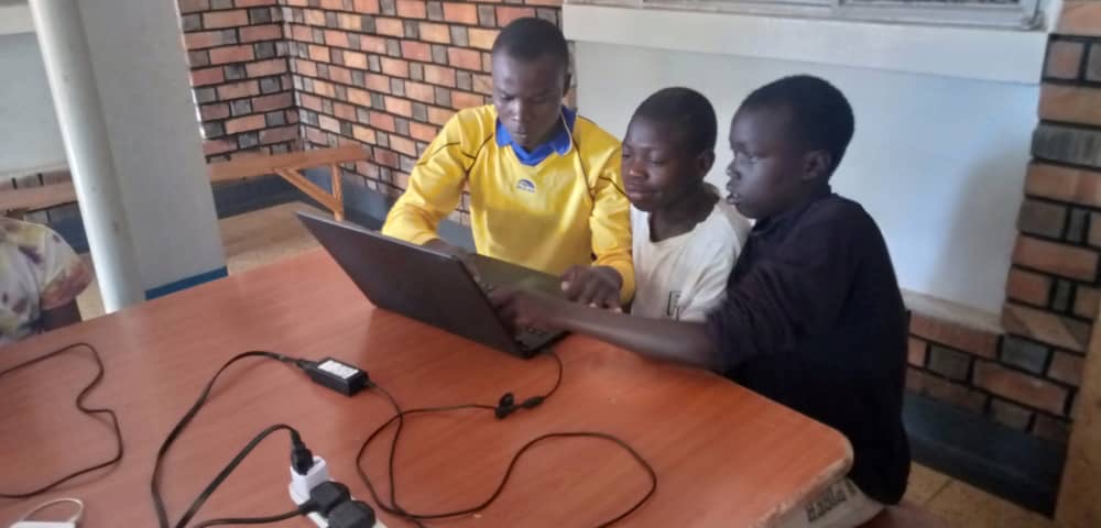 children on laptops in a classroom