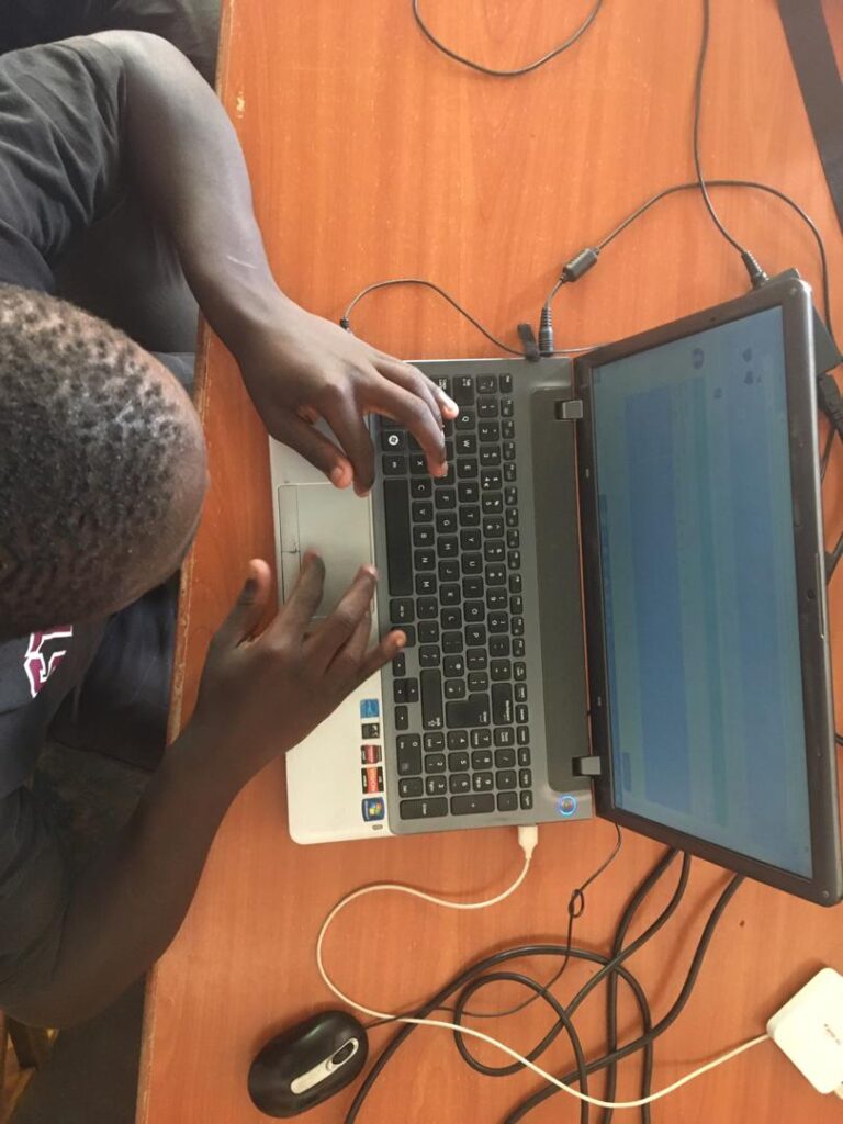 child on laptop in a classroom
