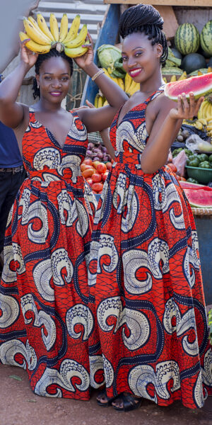 women in a market wearing traditional colourful Ugandan dresses