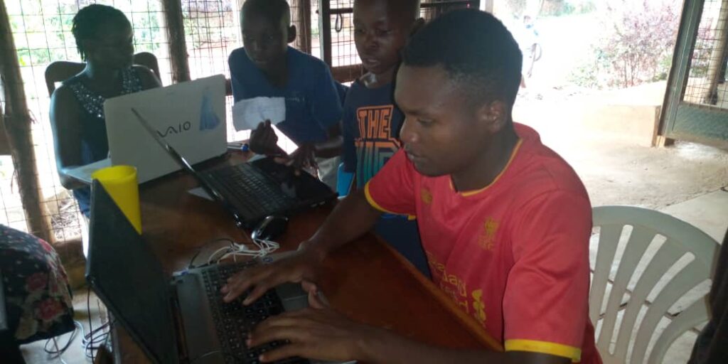 children on laptops in a classroom