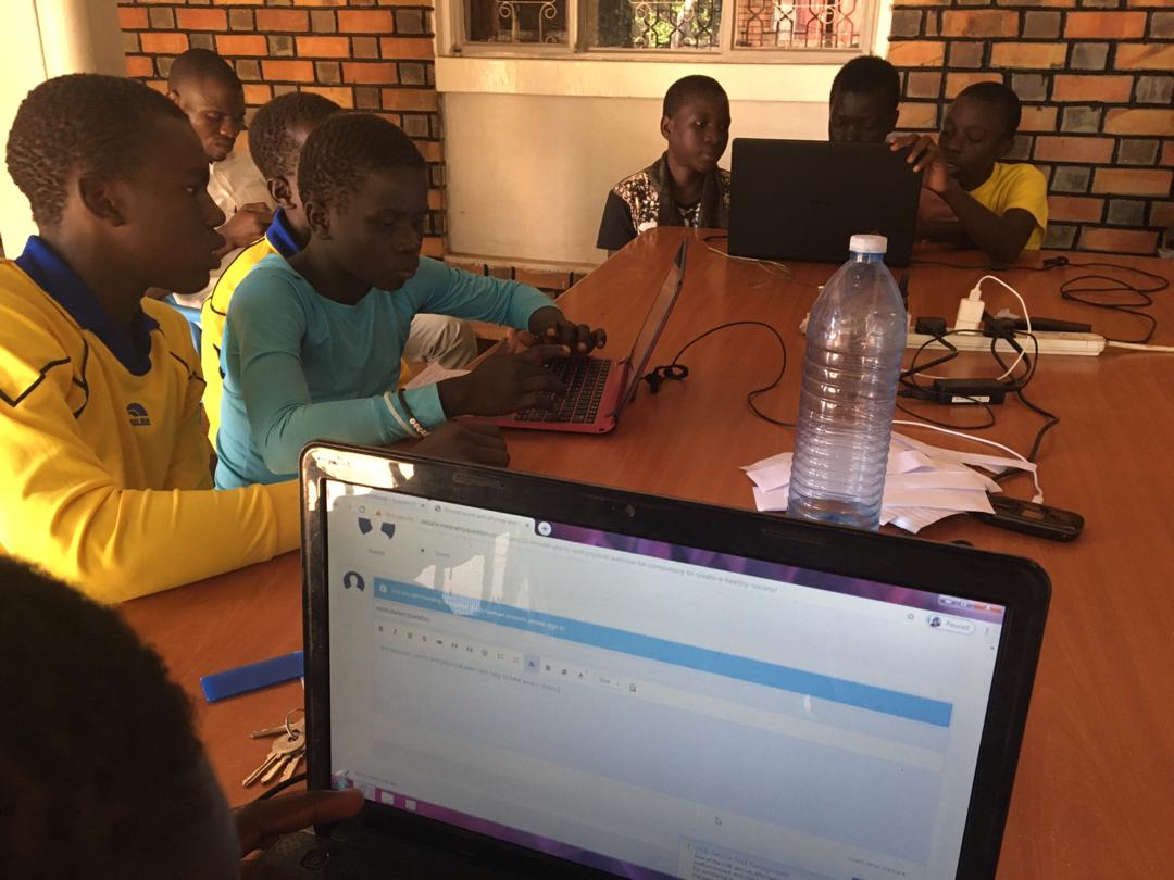 children on laptops in a classroom