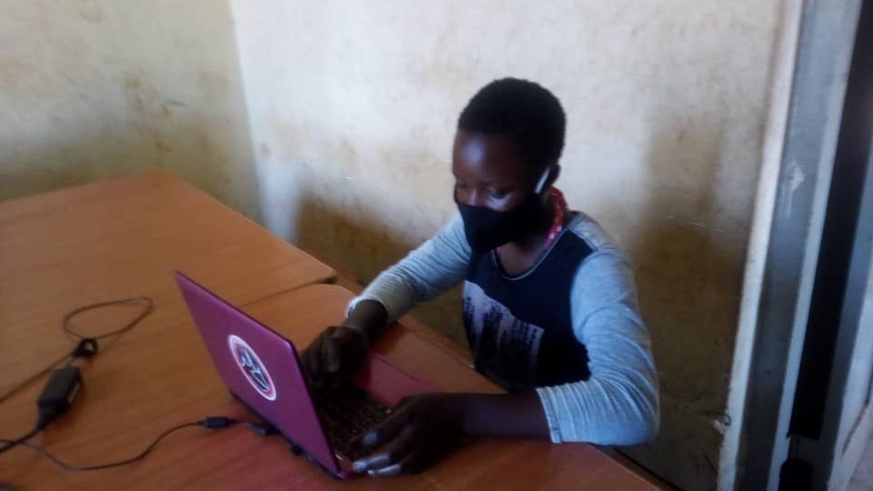 child on laptop in a classroom