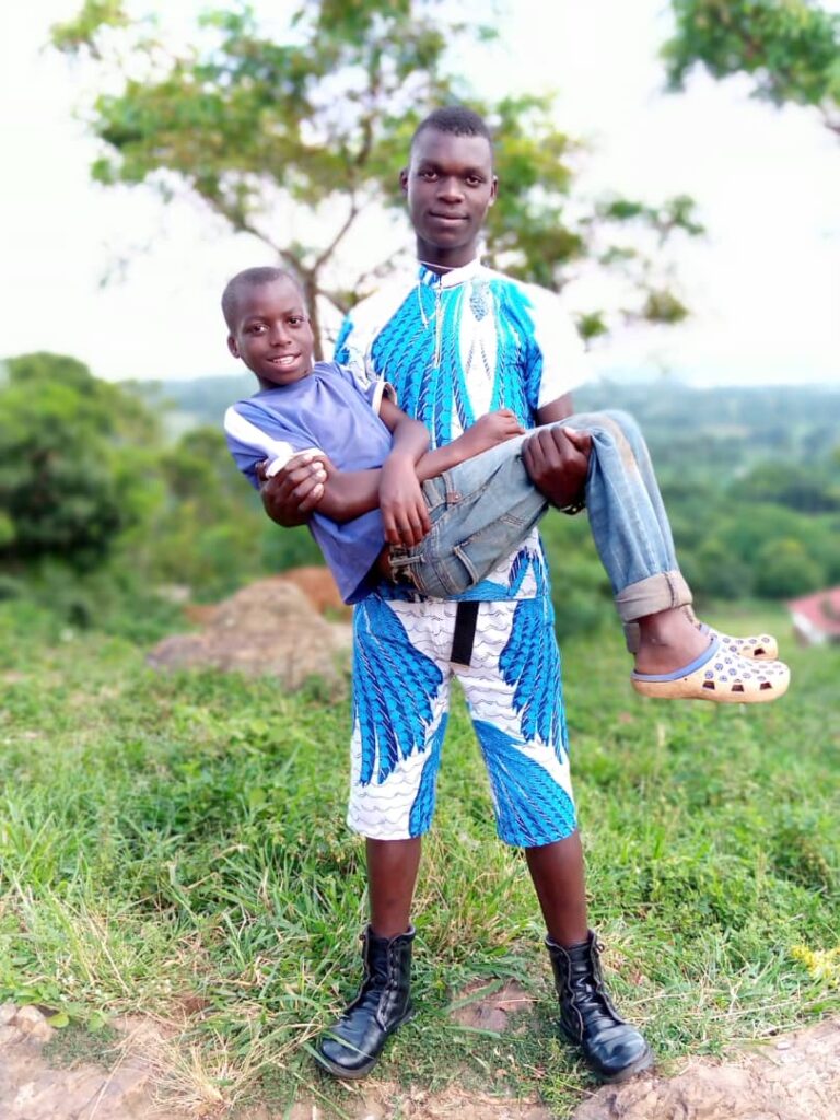 a young man carrying a boy