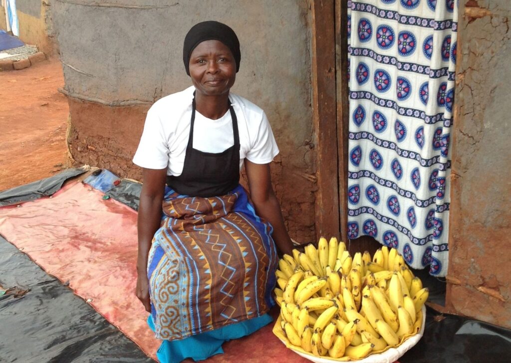 a woman next to a bowl of bananas