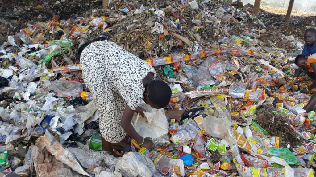 a girl at a rubbish heap