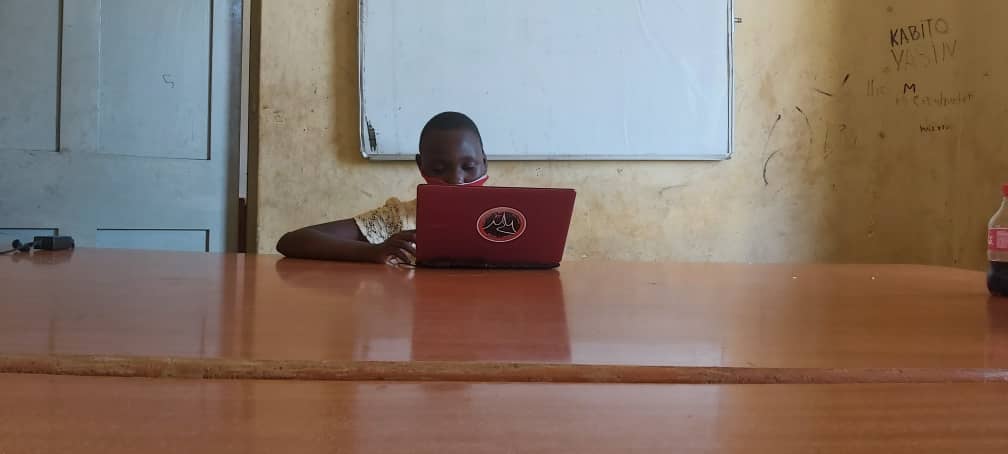 child on laptop in a classroom