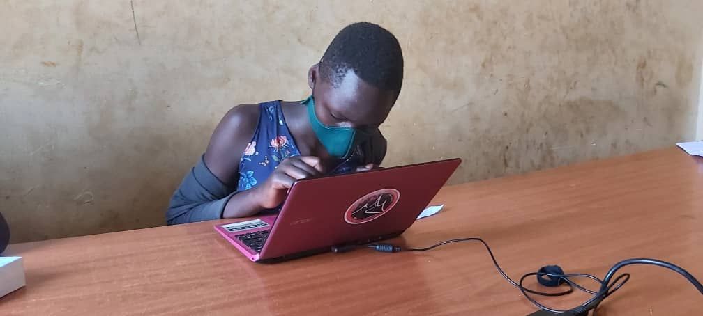 A child works on a laptop