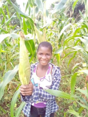 A child holding up corn