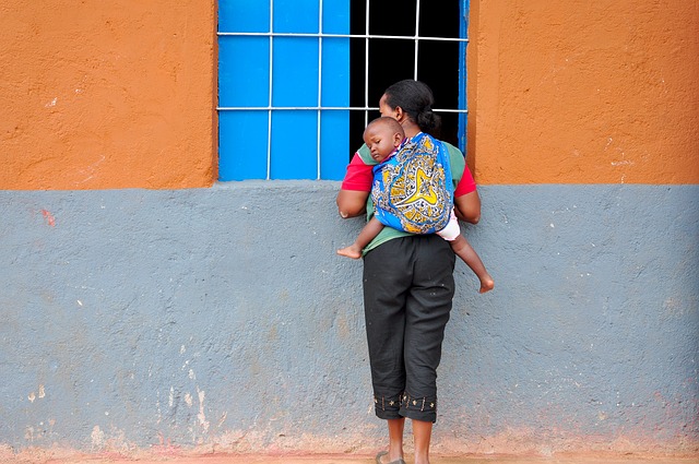 Mother with baby carried on her back