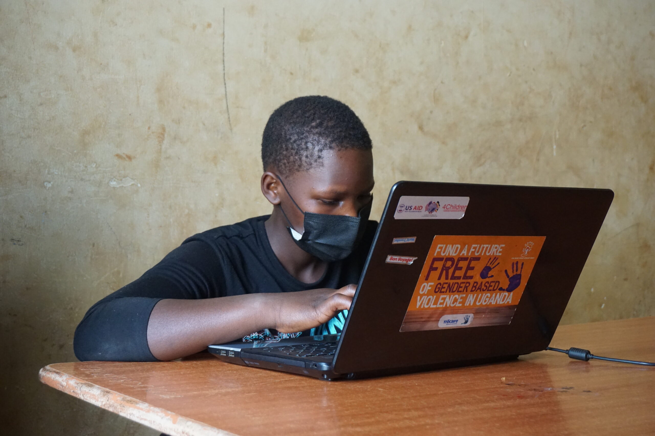 A child works on a laptop at a school