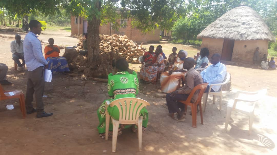 A teacher teaching a group of people about permaculture