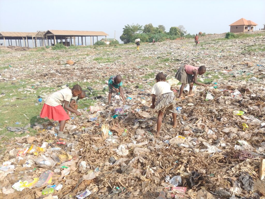Girls picking through an ocean of rubbish