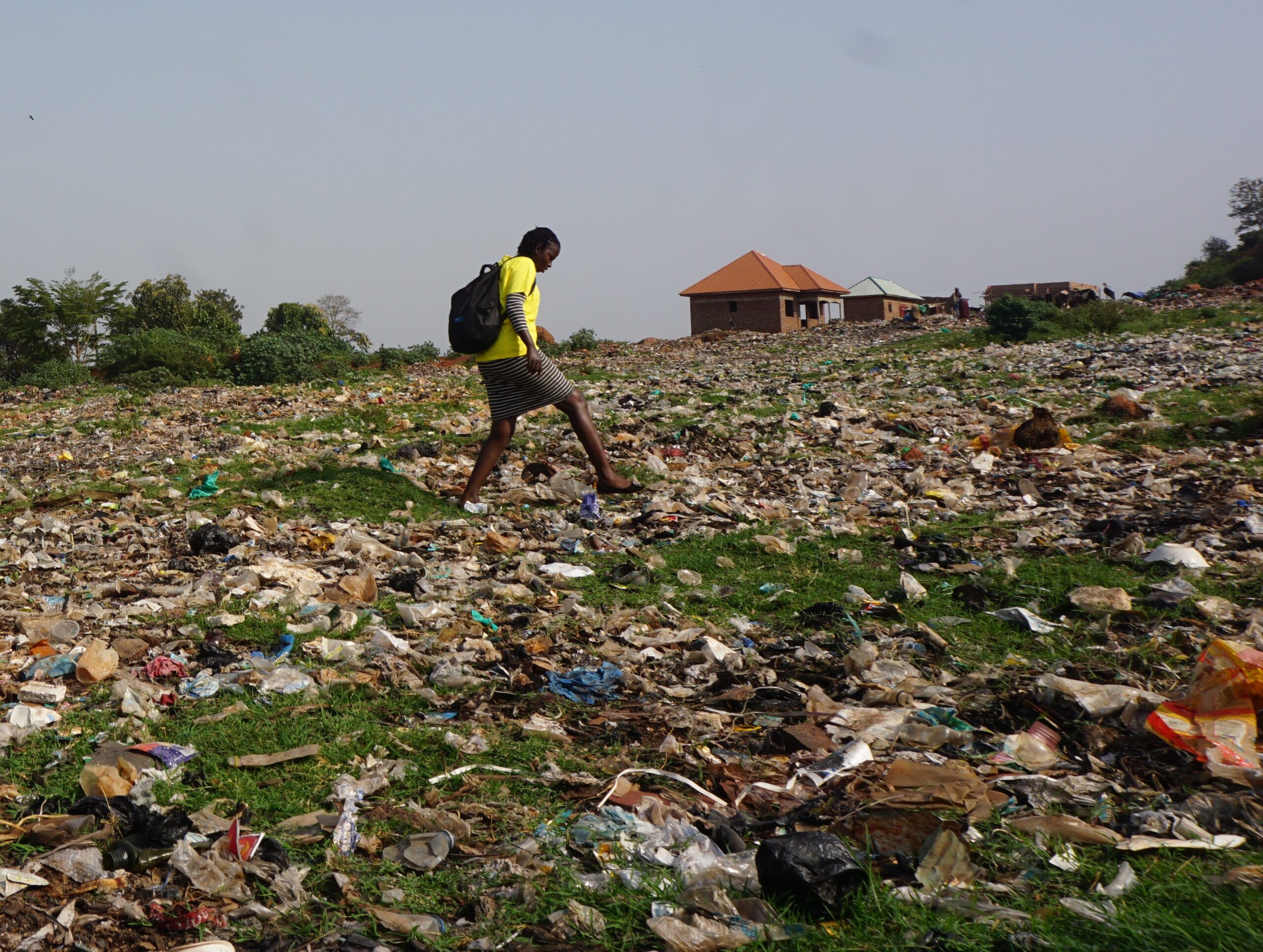 A S.A.L.V.E worked walking across a huge pile of rubbish