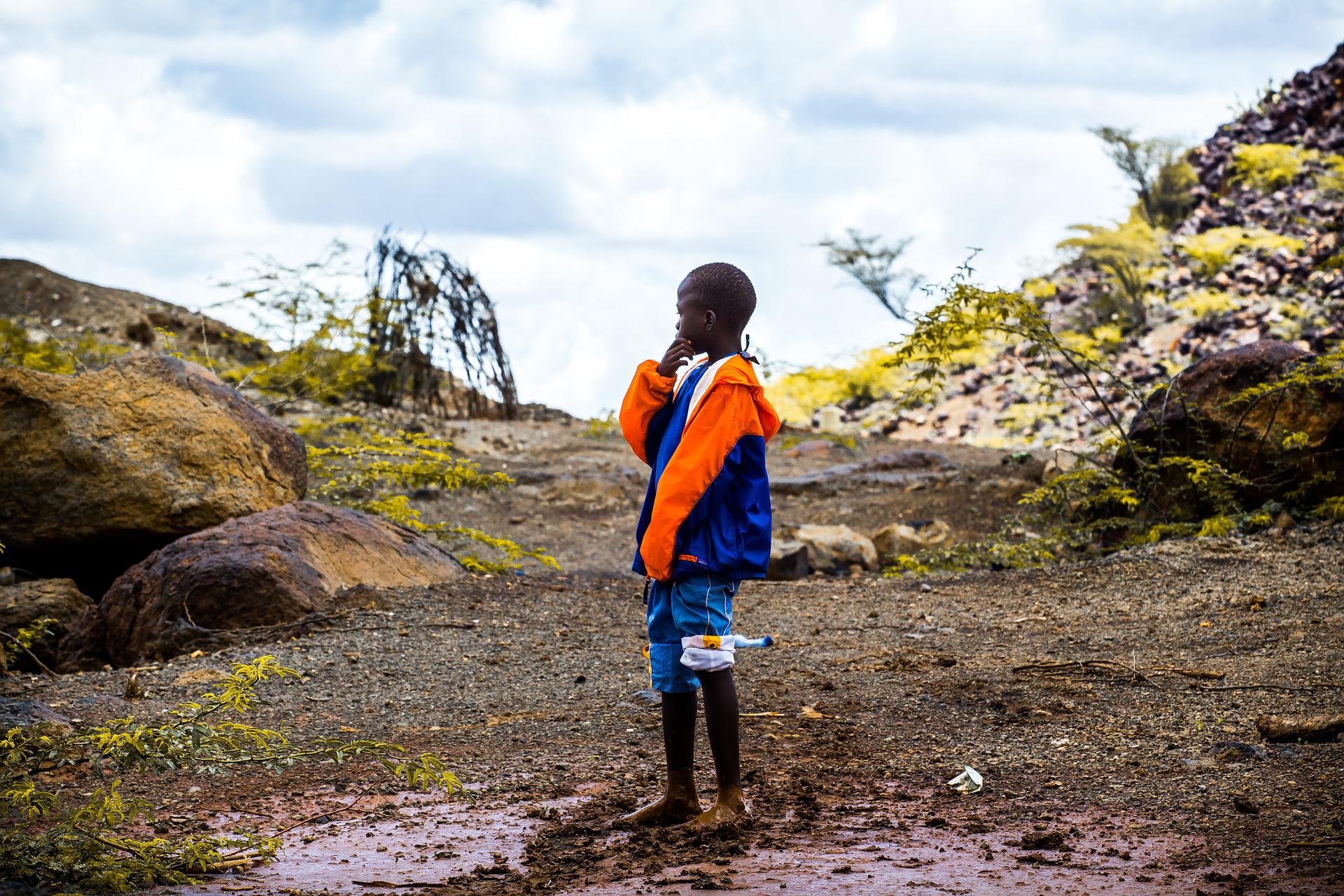 A boy pictured alone outside