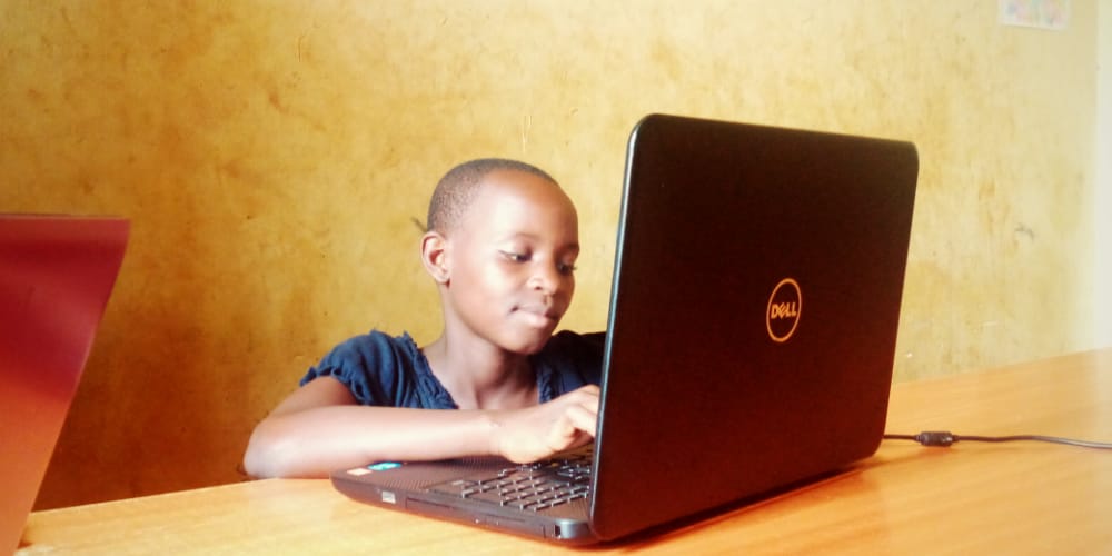 A child works on a laptop at a school
