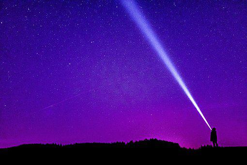 stock image of a beam of light set against the night sky