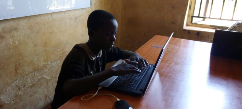 A child works on a laptop at a school