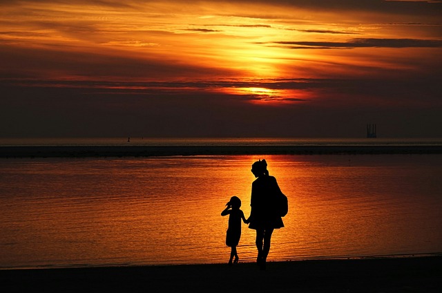 Mother and daughter walking in a sunset setting