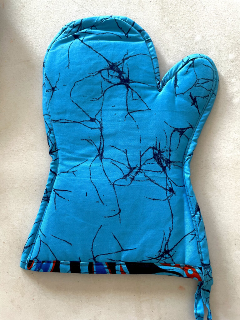 turquoise oven glove with black details