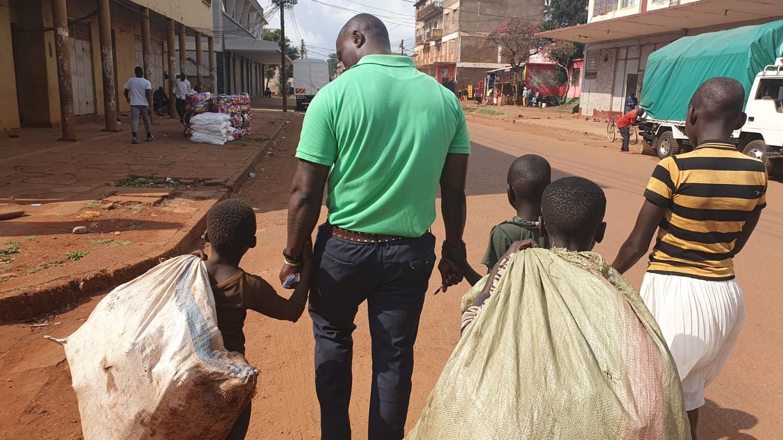 Alfred walking with children on the street