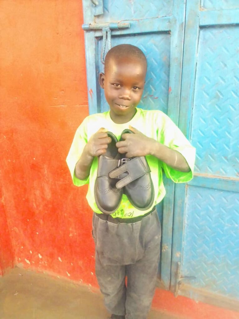 Boy holding a pair of shoes