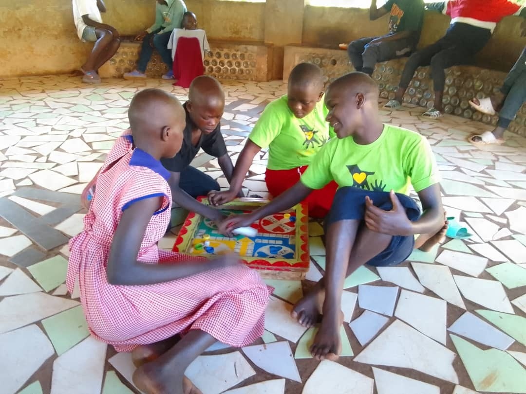 Children playing a game sat on the floor