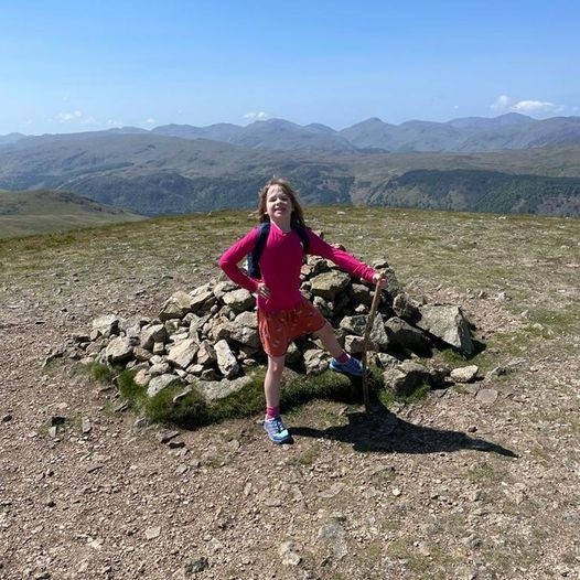 girl smiling on hill top