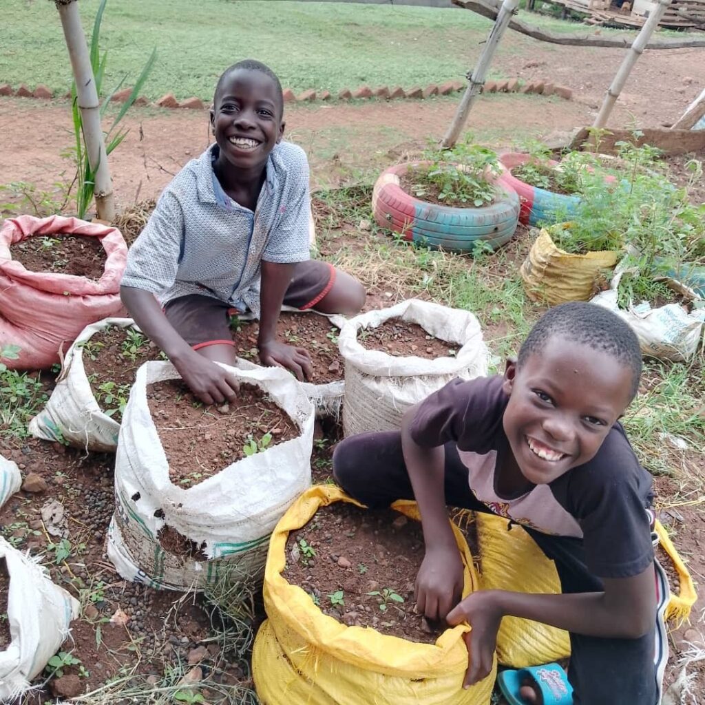 Children smiling with plants