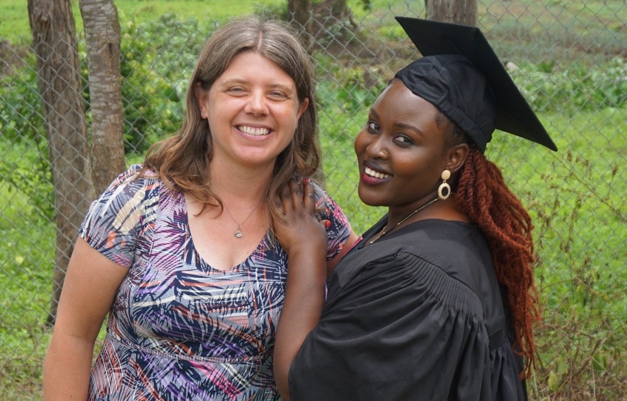 SALVE's CEO Nicola Sansom, standing with a woman who is wearing formal graduation wear and smiling